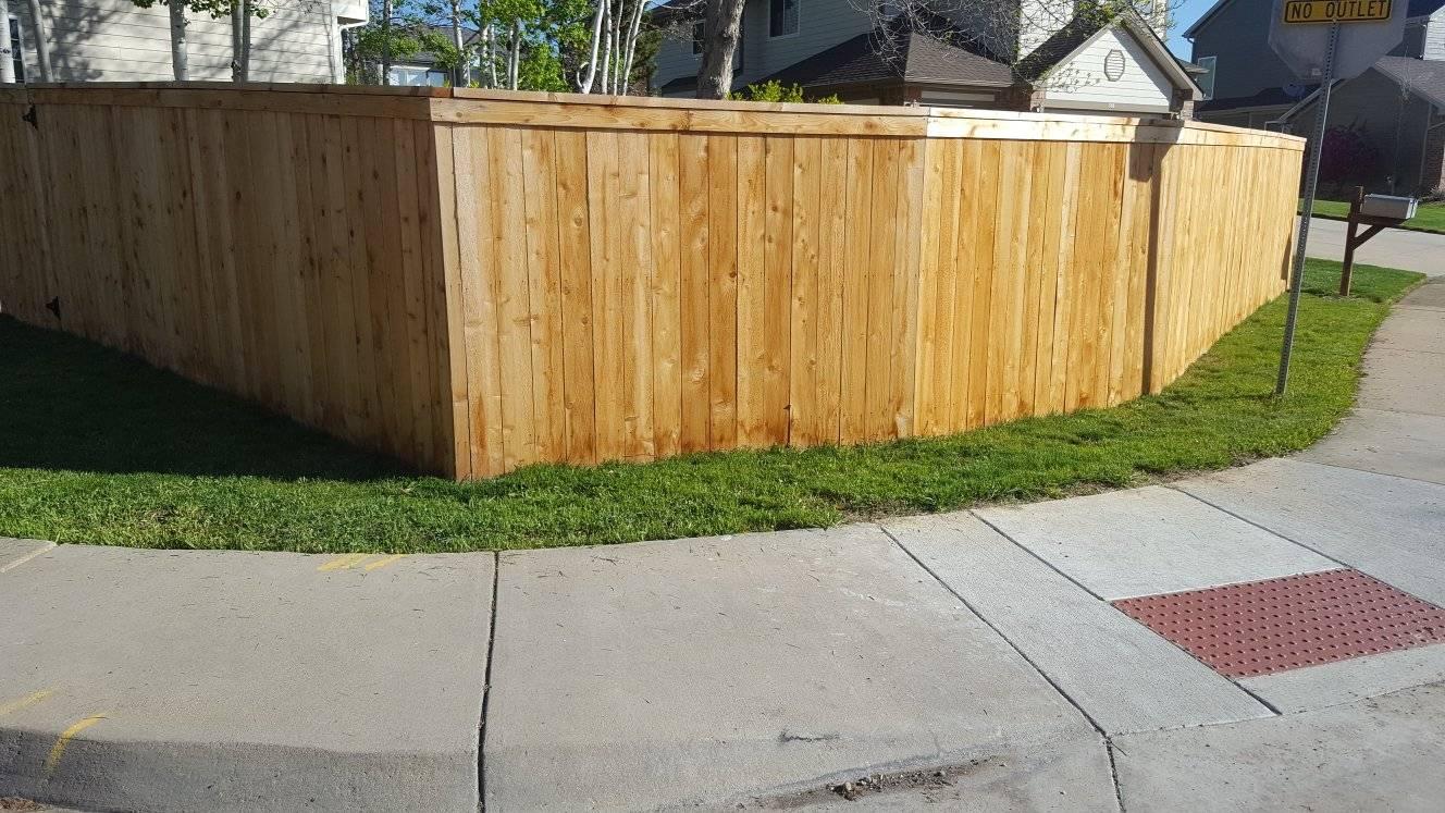 cedar fence on the corner of the street